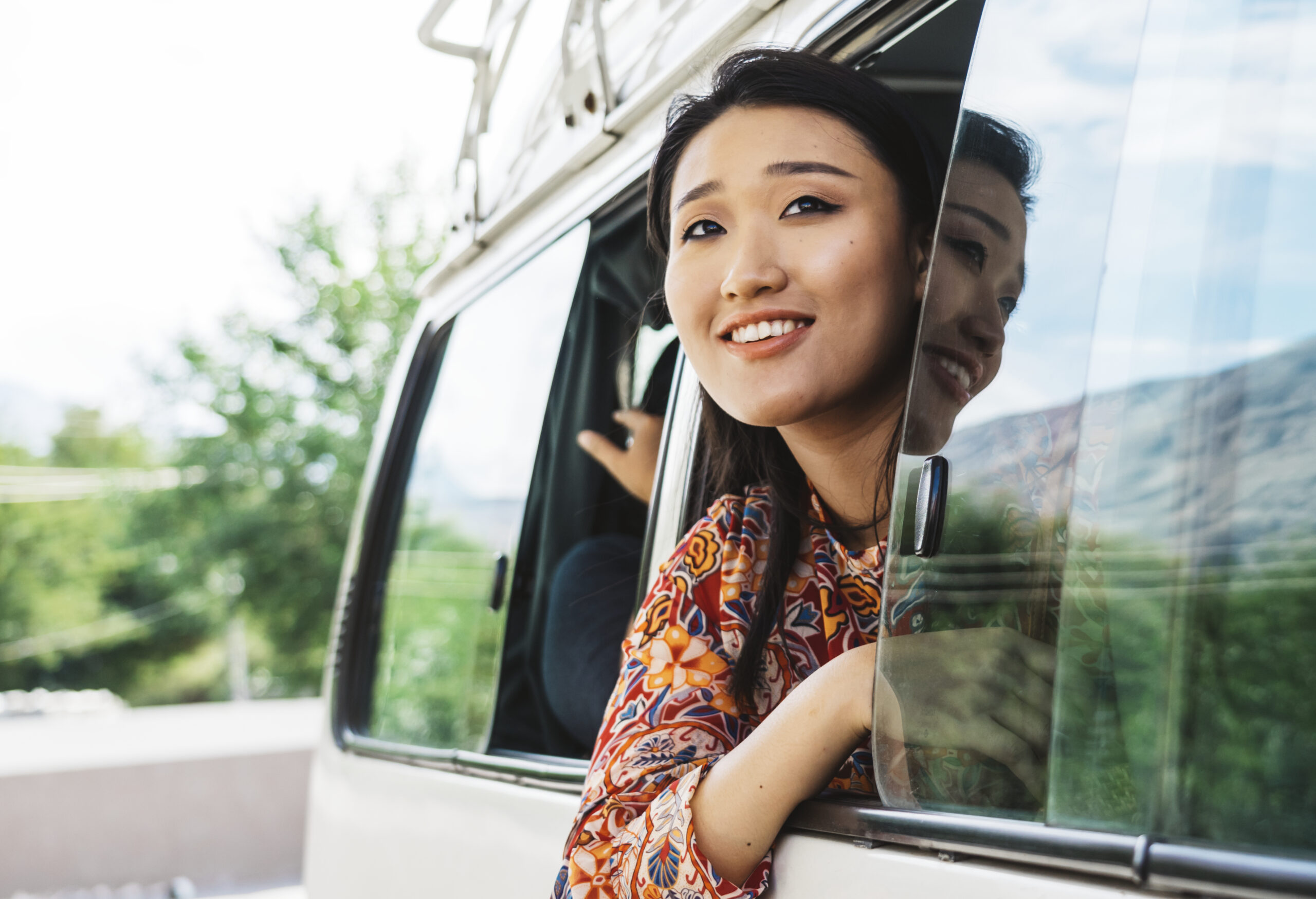 happy woman enjoying view from van scaled